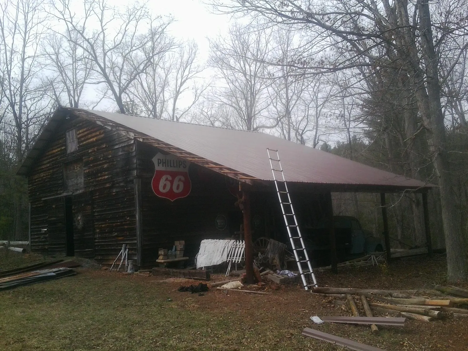 New metal roof on an open sided timber barn with a vintage sign in Milanville
