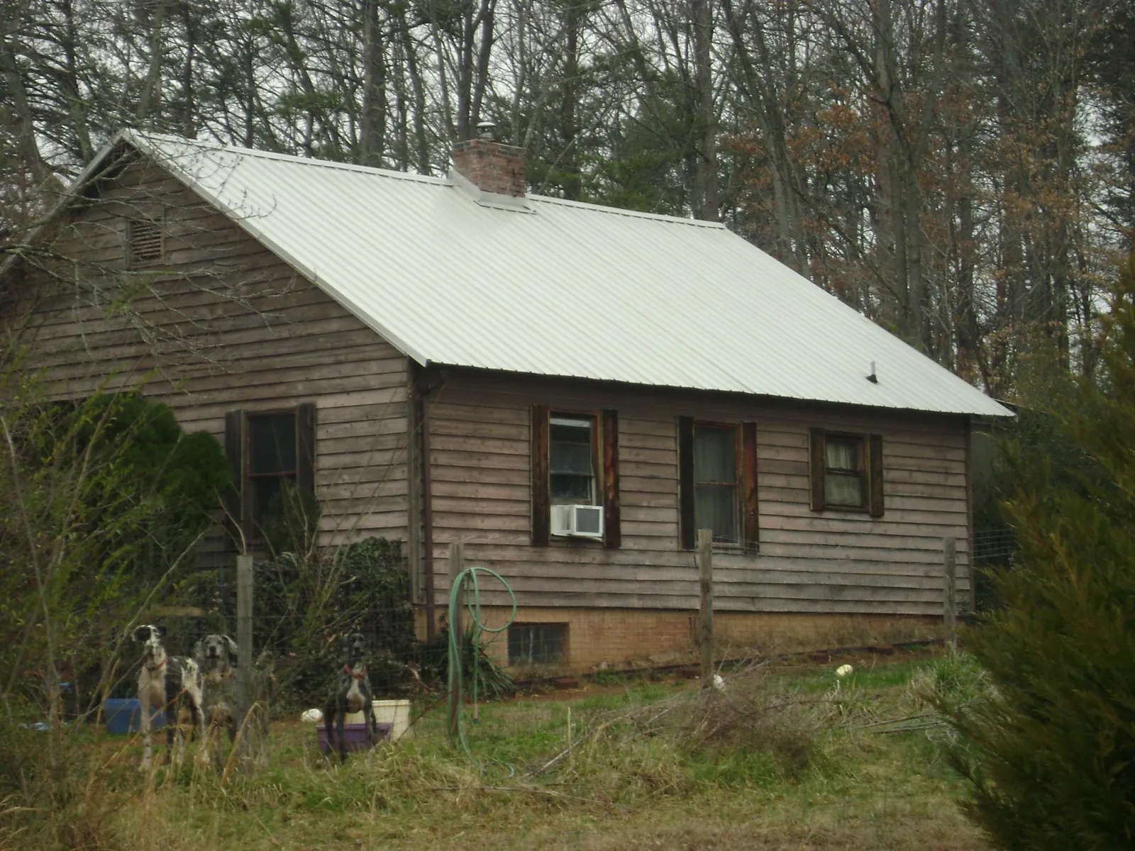 White metal roof on an old wood sided farmhouse, from a Metal Roof Installation job in Milanville